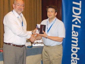 Adam Rawicz, Managing Director of TDK-Lambda EMEA, presents Philip Surman, Business Development Manager for PPM’s Test and Instrumentation Division, with the Distributor of the Year award.